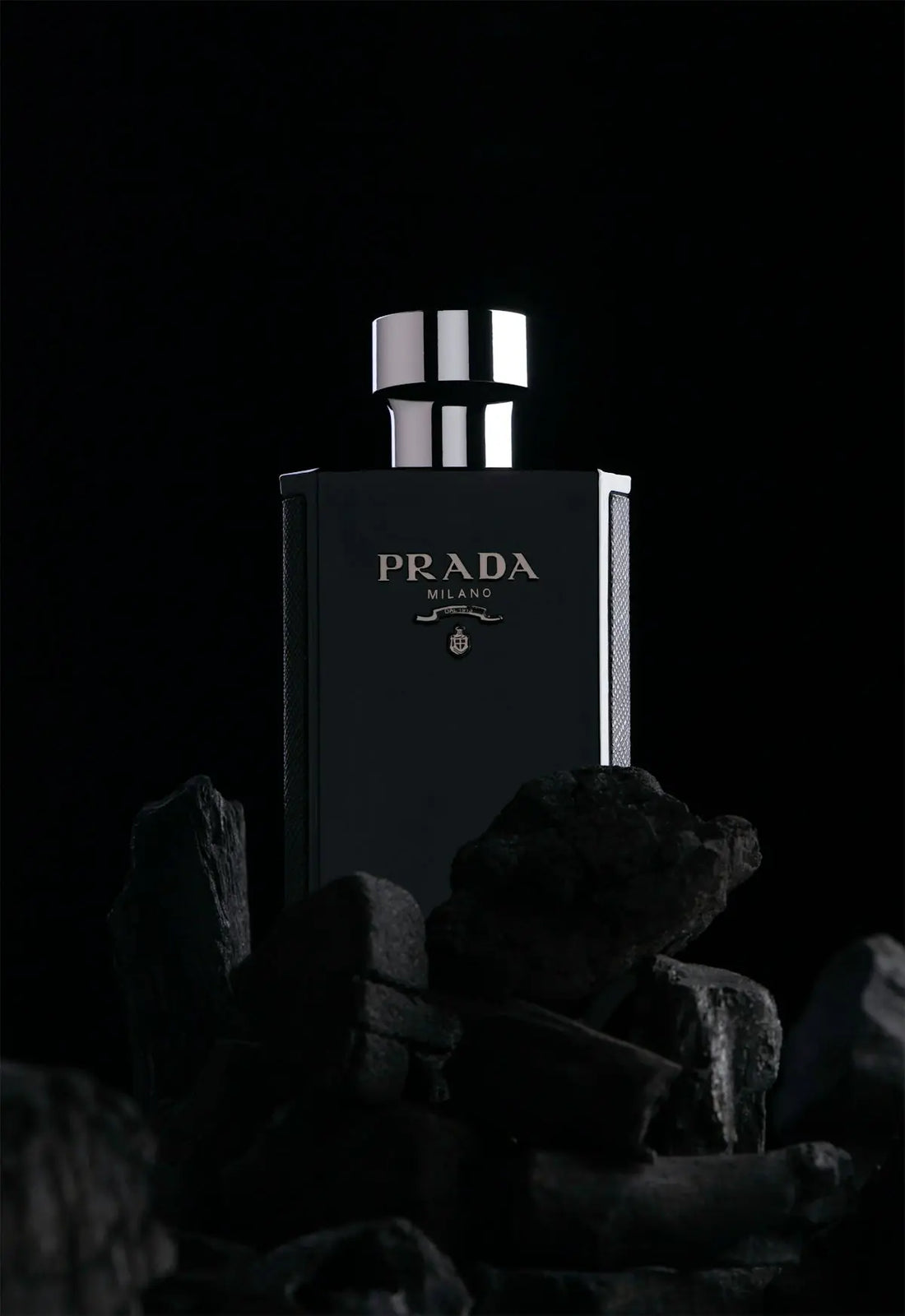 a black and white photo of a bottle of prada