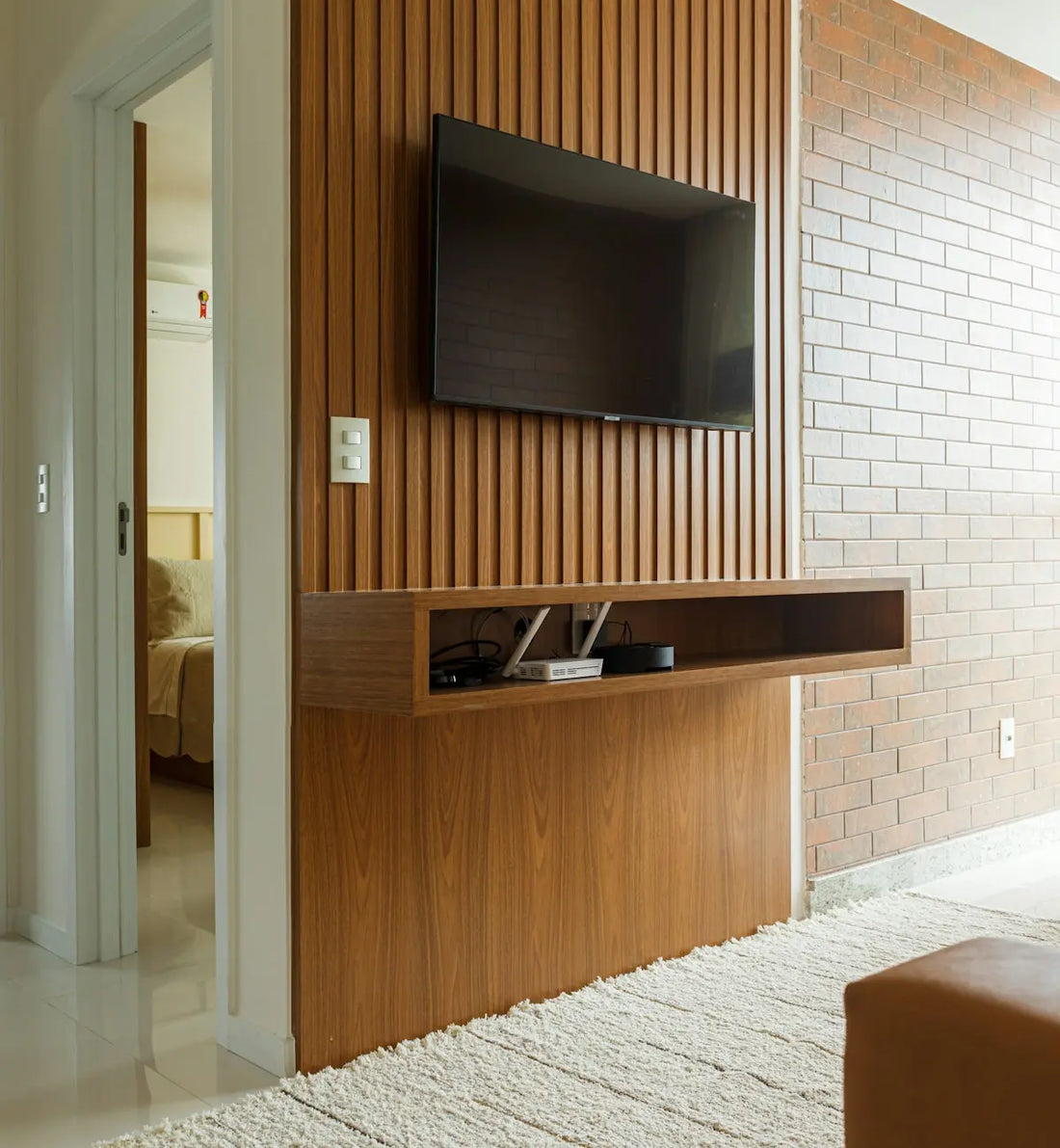 a flat screen tv mounted on a wooden wall