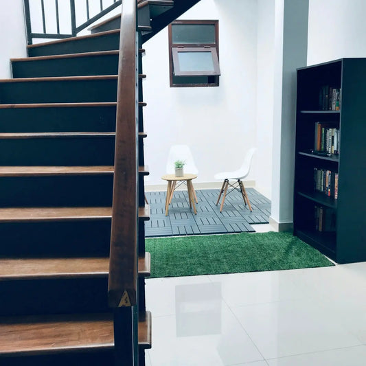 brown wooden staircase near white wall