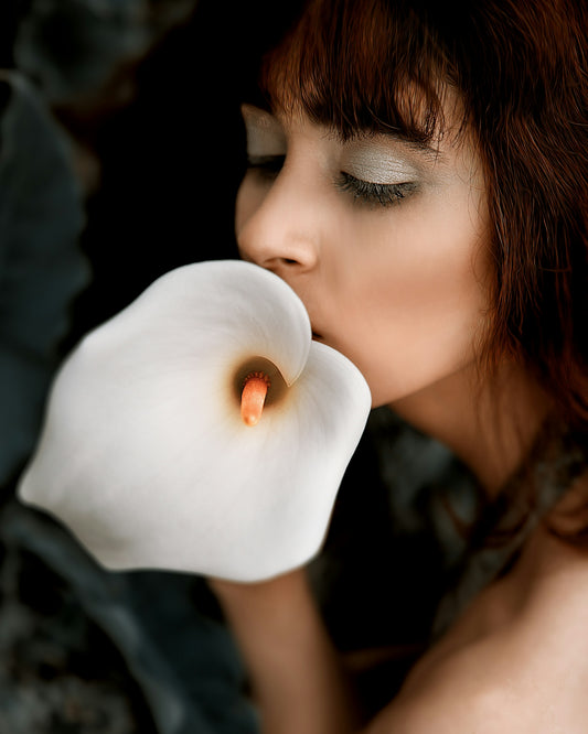 a woman with a flower in her mouth