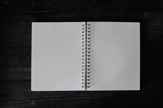 an open notebook on a wooden table