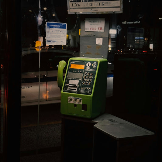A green machine sitting on top of a parking meter